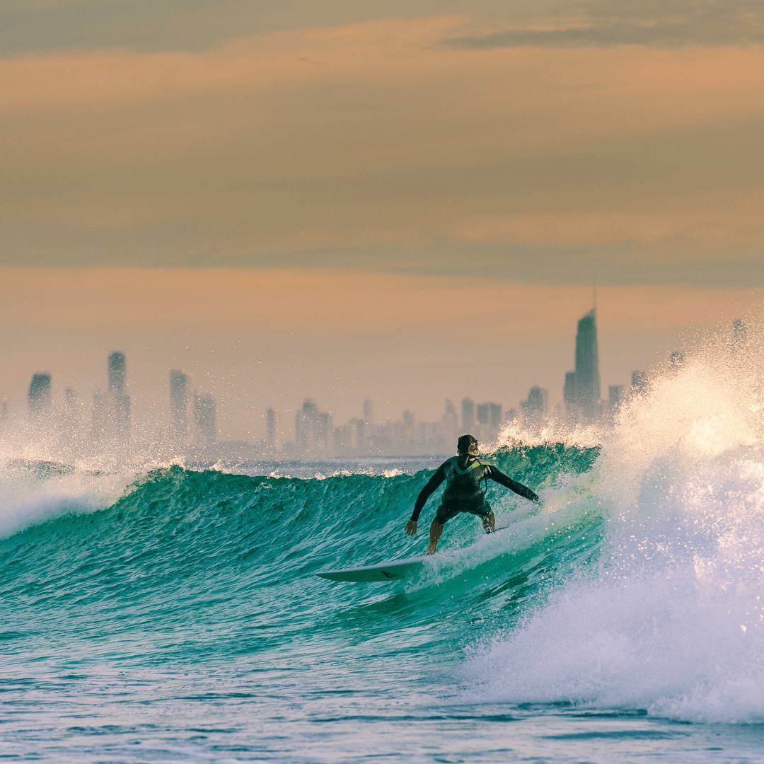 A man rides a wave in the ocean, capturing the energy and beauty of the sea.