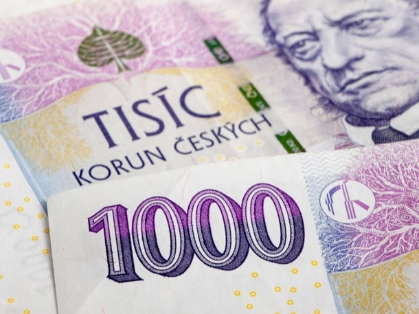 The image shows a close-up of Czech currency, specifically the 1000 Korun banknote with intricate designs and the portrait of a historical figure. The detailed security features and cultural significance make it interesting.